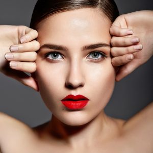 High fashion look.glamor closeup portrait of beautiful sexy stylish brunette Caucasian young woman model with bright makeup, with red lips,  with perfect clean skin in studio